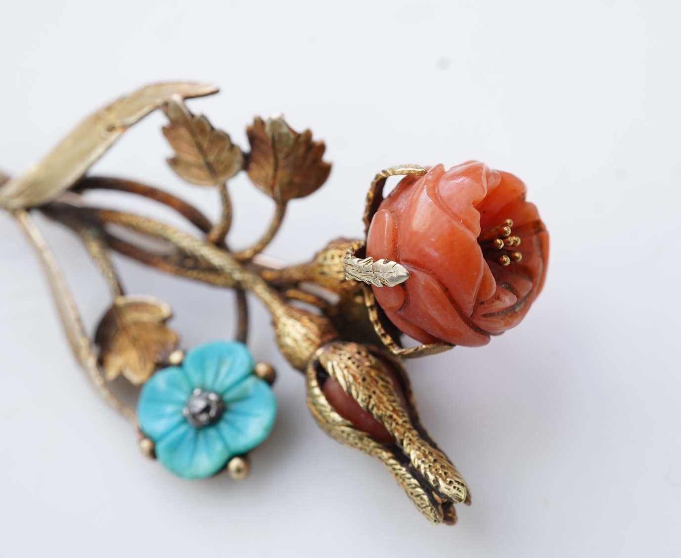 A gold, coral and turquoise brooch, circa 1840